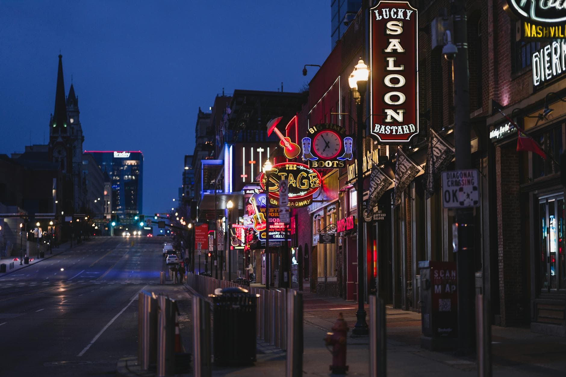 Lower Broadway in Nashville at golden hour — neon signs warming under late afternoon light