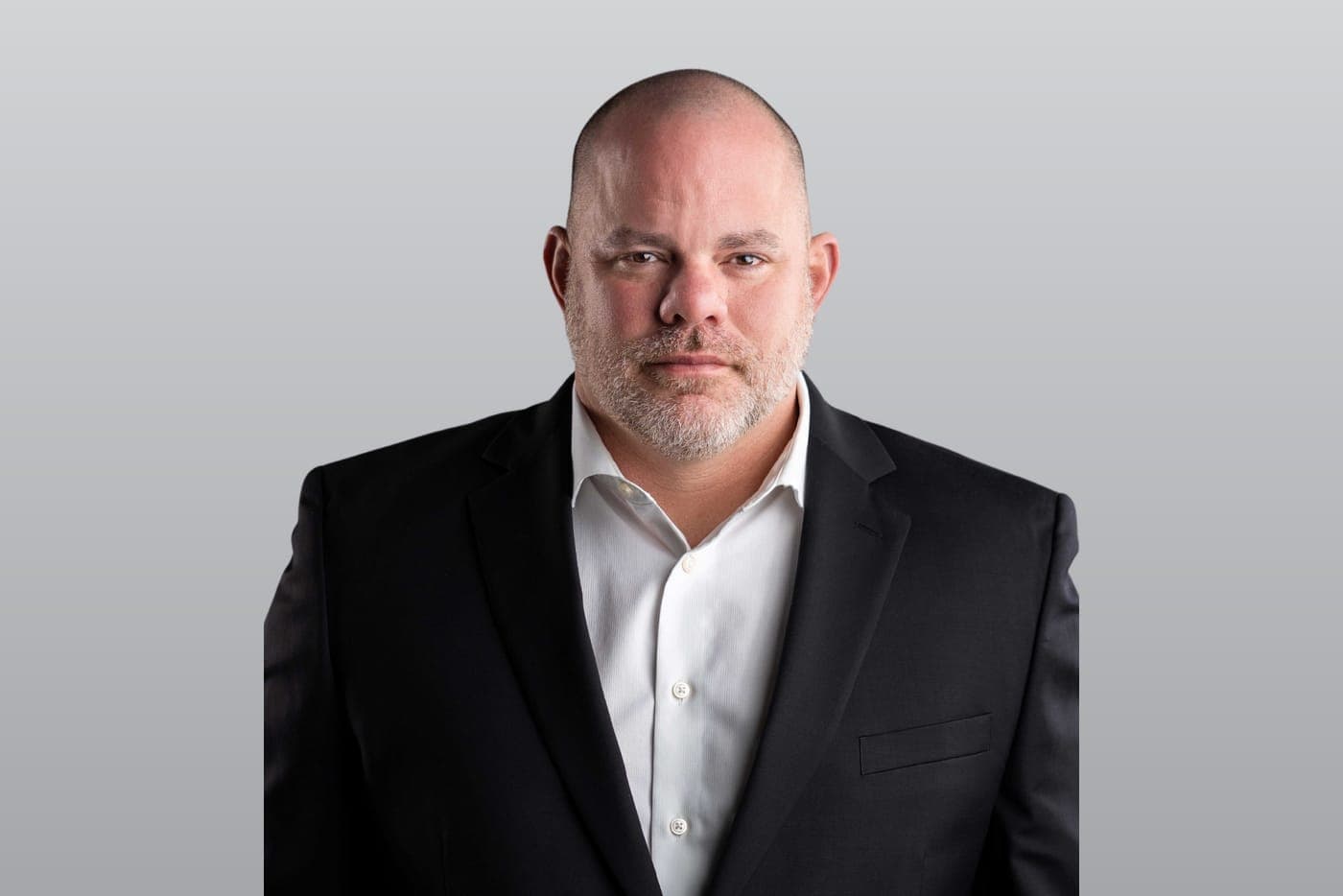John Barrs, Keller Williams Music City agent, studio portrait on a gray backdrop