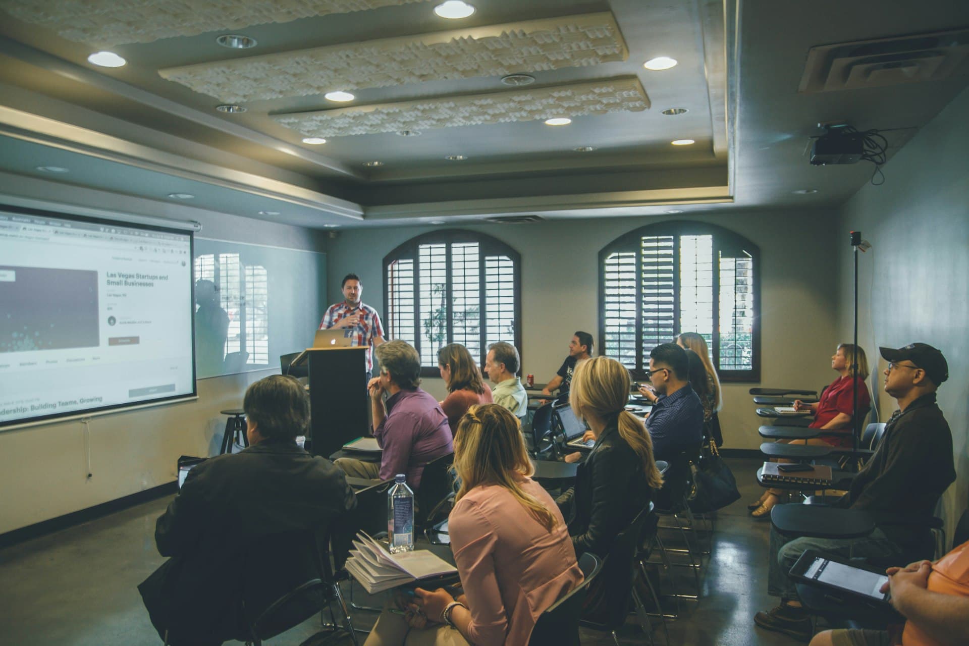 ACTIVATE 100-day coaching cohort gathered around a strategy whiteboard at a KW Empower market center