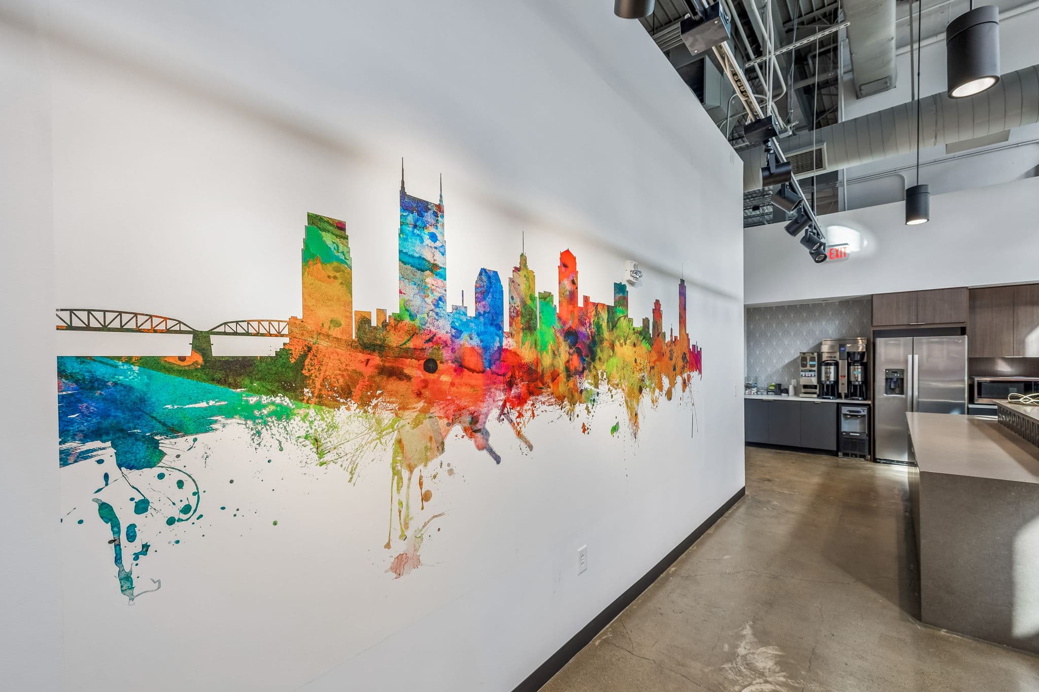 Nashville skyline mural anchoring the KW Nashville Music City office