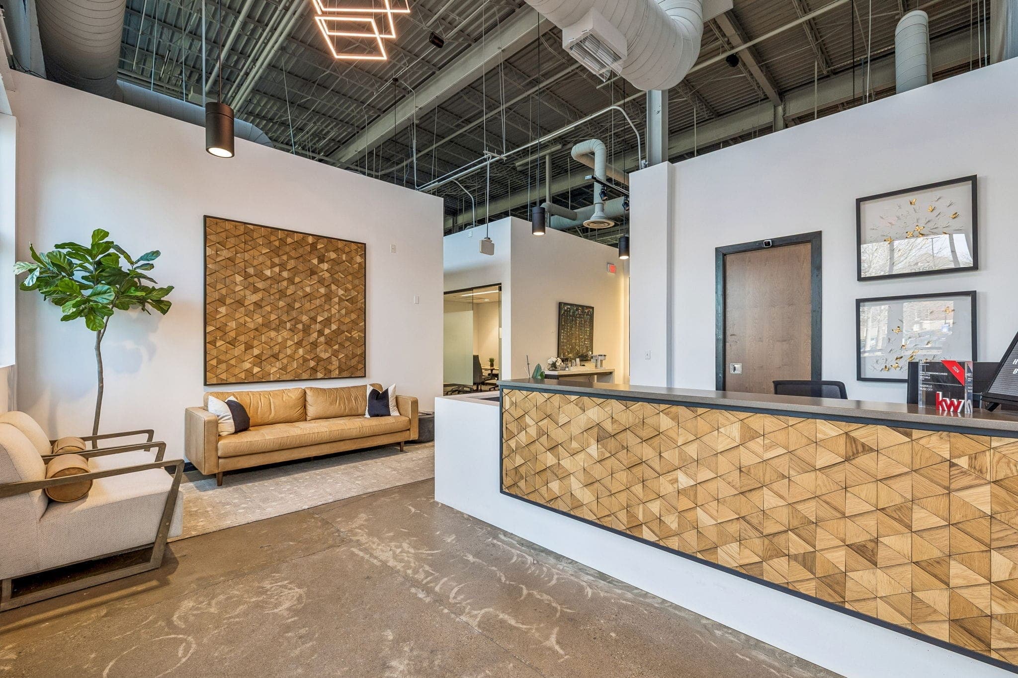 Welcoming lobby at Keller Williams Nashville Music City — warm wood, leather seating, and natural light greeting strategic alliance partners